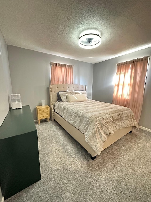 bedroom with a textured ceiling and carpet