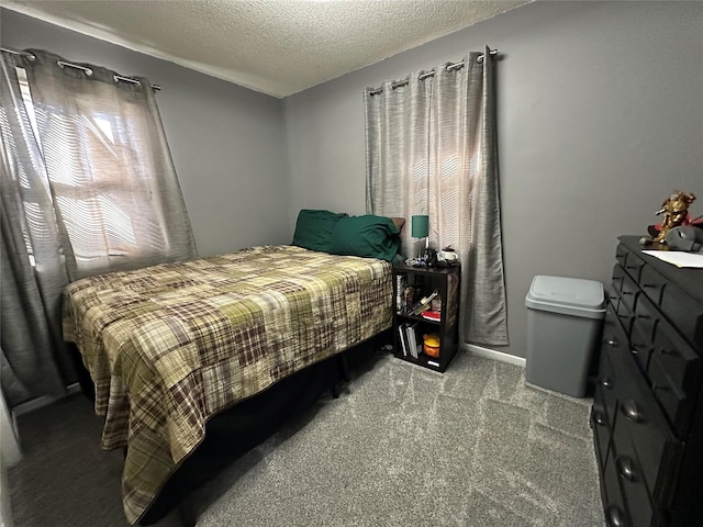 carpeted bedroom featuring a textured ceiling