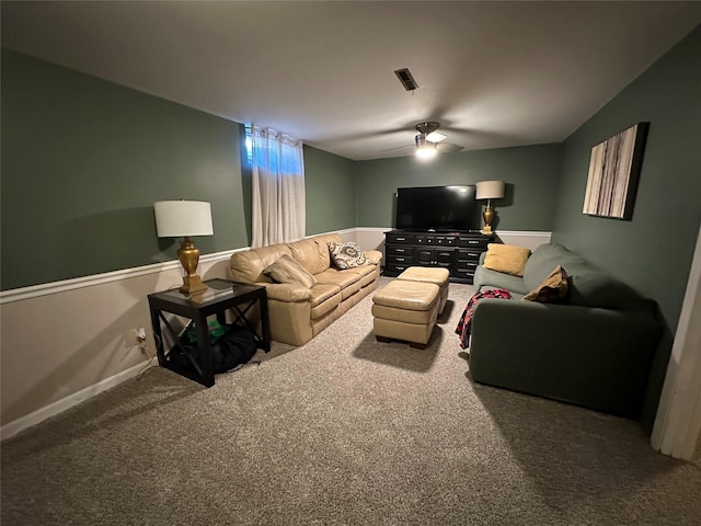 carpeted living room with ceiling fan