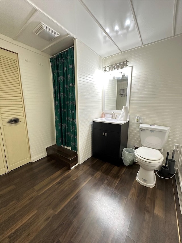 bathroom with hardwood / wood-style flooring, vanity, toilet, and a shower with shower curtain