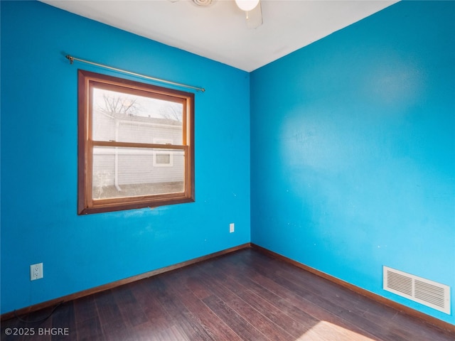 spare room featuring dark hardwood / wood-style floors and ceiling fan