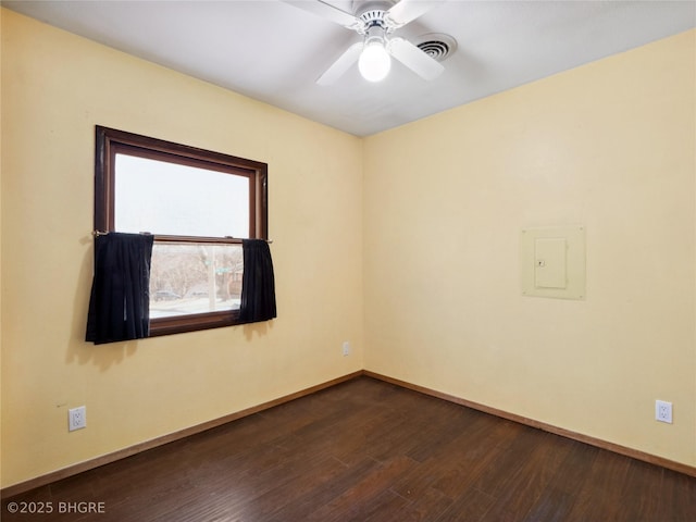 unfurnished room with ceiling fan, dark hardwood / wood-style flooring, and electric panel