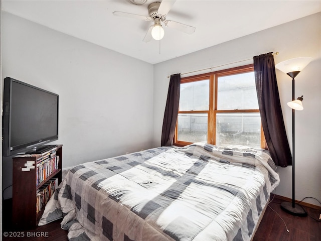 bedroom with dark wood-type flooring and ceiling fan