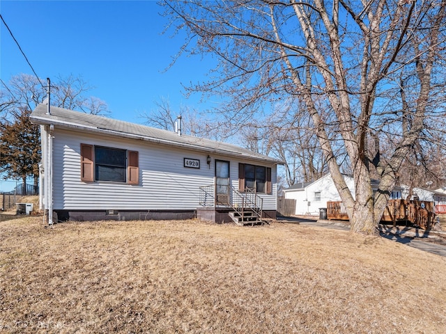 view of front of home with central AC and a front yard