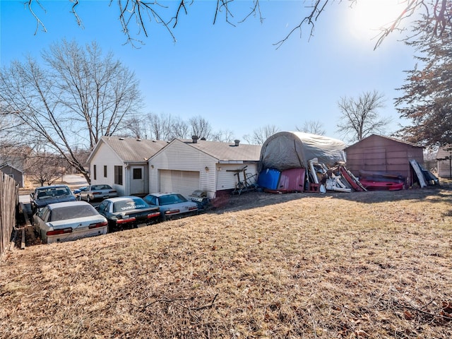 exterior space featuring a garage and a front lawn