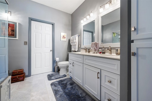 bathroom featuring vanity, toilet, and tile patterned flooring