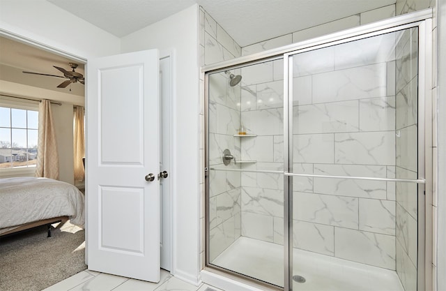 full bath with marble finish floor, a stall shower, a textured ceiling, connected bathroom, and ceiling fan