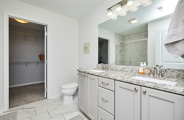 bathroom with a sink, visible vents, marble finish floor, and a stall shower