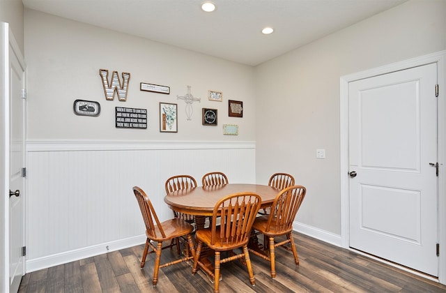 dining space featuring a wainscoted wall, recessed lighting, dark wood-type flooring, and baseboards