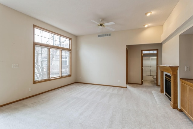 unfurnished living room with ceiling fan and light colored carpet