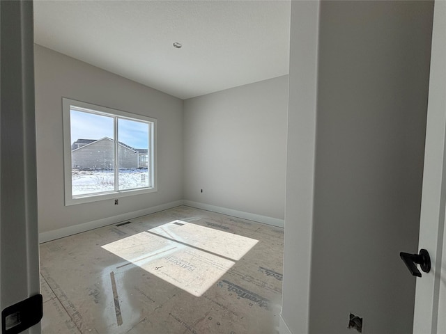 spare room with visible vents and baseboards