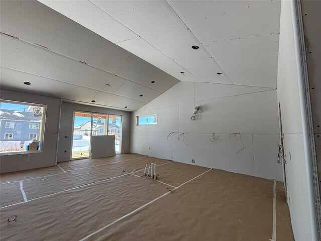 empty room with lofted ceiling