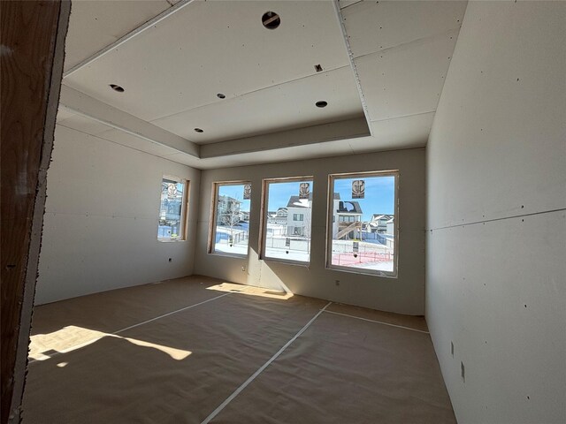 empty room featuring a tray ceiling