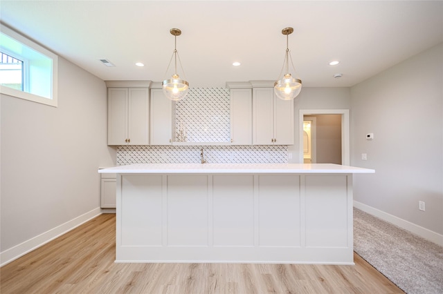 16217 Walnut Meadows Ct, Urbandale, IA 50323 - kitchen with light countertops, tasteful backsplash, baseboards, light wood-style flooring, and recessed lighting