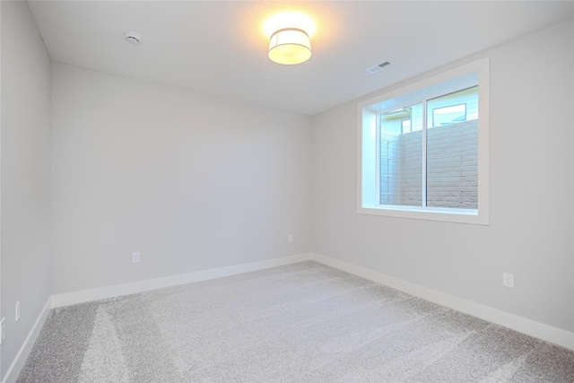 16217 Walnut Meadows Ct, Urbandale, IA 50323 - spare room featuring carpet floors, a smoke detector, and baseboards