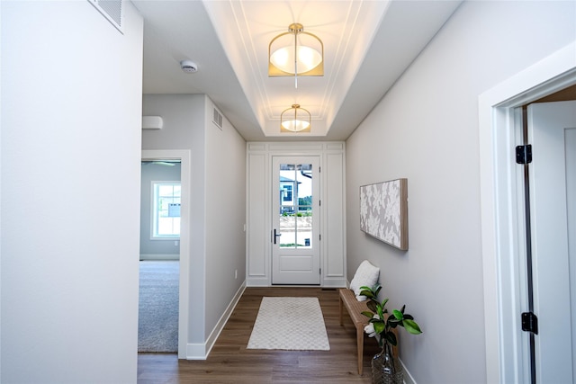 16217 Walnut Meadows Ct, Urbandale, IA 50323 - entryway with wood finished floors, baseboards, a tray ceiling, and a chandelier