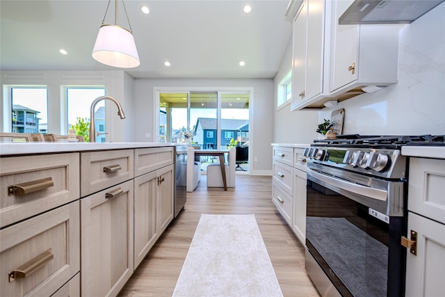 16217 Walnut Meadows Ct, Urbandale, IA 50323 - kitchen featuring stainless steel appliances, under cabinet range hood, healthy amount of natural light, light countertops, and recessed lighting