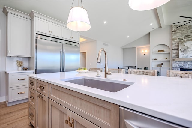 16217 Walnut Meadows Ct, Urbandale, IA 50323 - kitchen with a sink, stainless steel appliances, light countertops, and hanging light fixtures