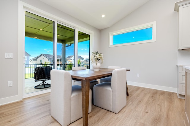 16217 Walnut Meadows Ct, Urbandale, IA 50323 - dining area with light wood-type flooring, vaulted ceiling, and baseboards