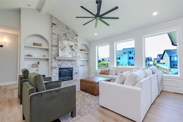16217 Walnut Meadows Ct, Urbandale, IA 50323 - living area with ceiling fan, light wood-type flooring, a stone fireplace, built in shelves, and baseboards