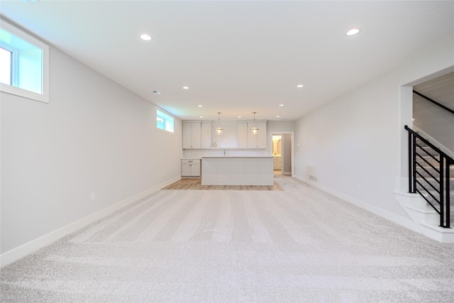 16217 Walnut Meadows Ct, Urbandale, IA 50323 - unfurnished living room featuring recessed lighting, light carpet, and baseboards