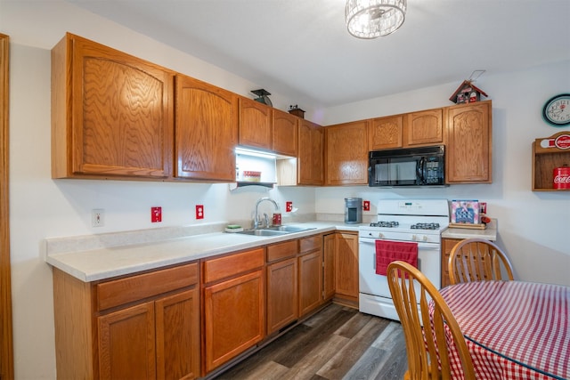 kitchen with sink, dark hardwood / wood-style floors, and white range with gas stovetop