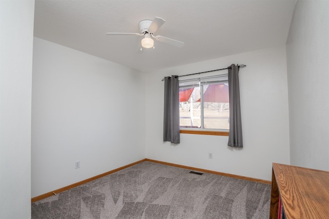 carpeted empty room featuring ceiling fan