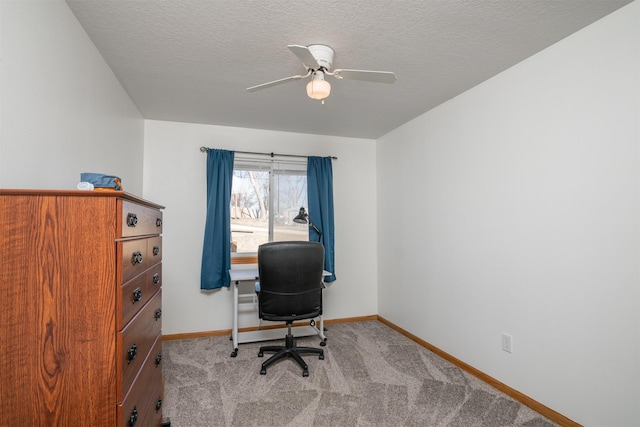 office area featuring ceiling fan, light carpet, and a textured ceiling