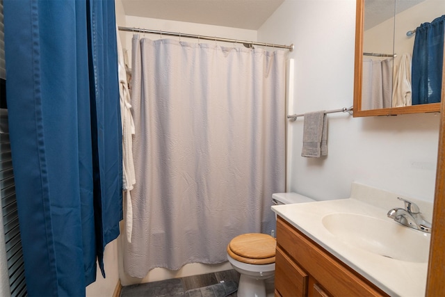 bathroom with hardwood / wood-style flooring, vanity, walk in shower, and toilet