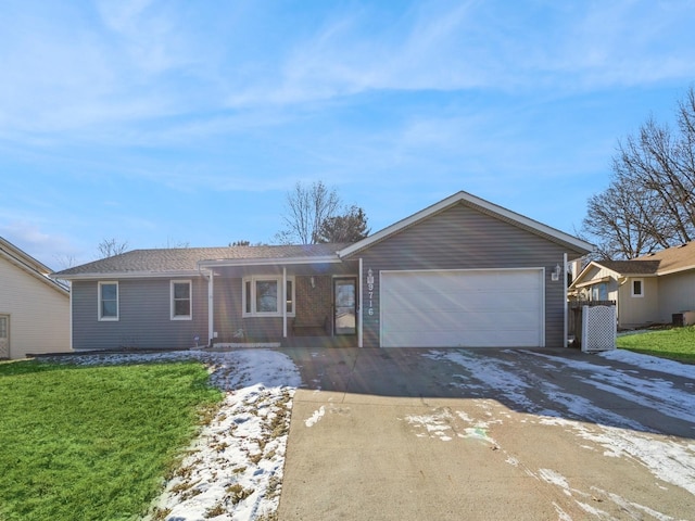 ranch-style home with a garage and a front lawn