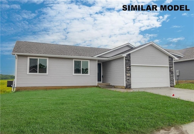 ranch-style home with a garage and a front lawn