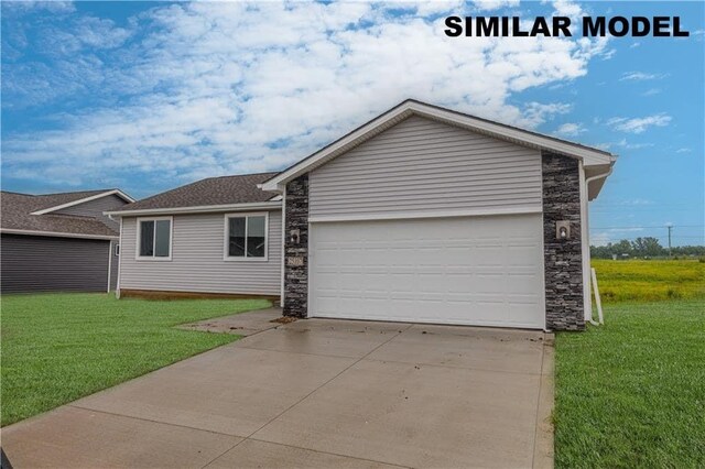 single story home with a garage and a front yard