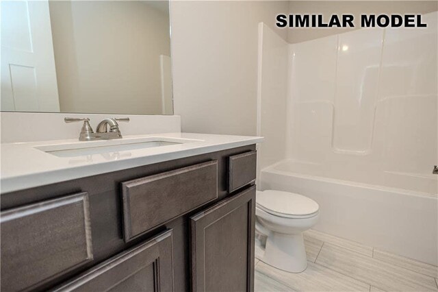 full bathroom featuring shower / bathing tub combination, vanity, and toilet