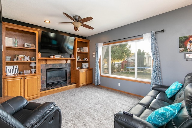 living room featuring ceiling fan, light colored carpet, and a fireplace