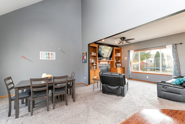 carpeted dining area featuring ceiling fan