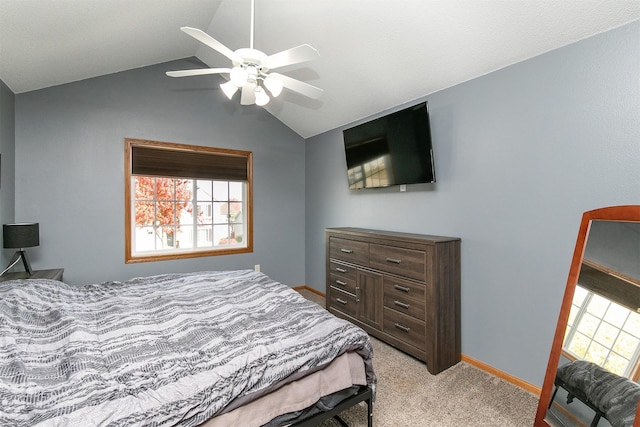 carpeted bedroom with vaulted ceiling and ceiling fan