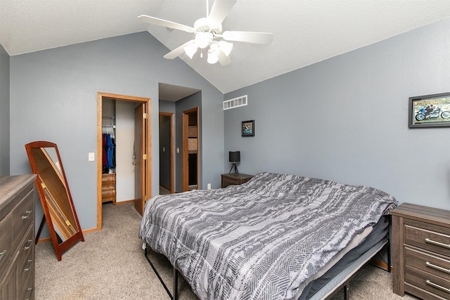 bedroom featuring light carpet, vaulted ceiling, and ceiling fan