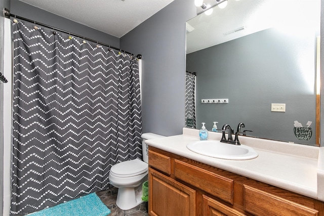 bathroom featuring vanity, a textured ceiling, curtained shower, and toilet