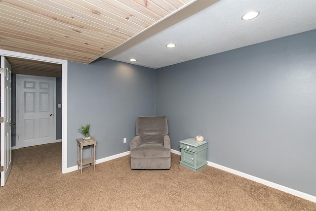 living area featuring wood ceiling and carpet floors