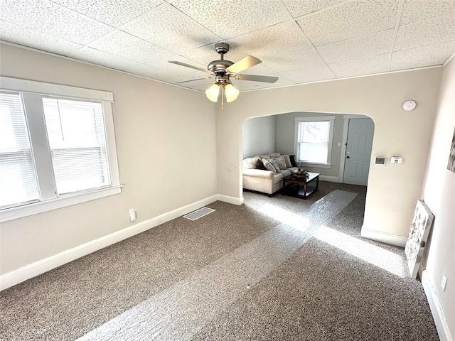 unfurnished room featuring ceiling fan and carpet