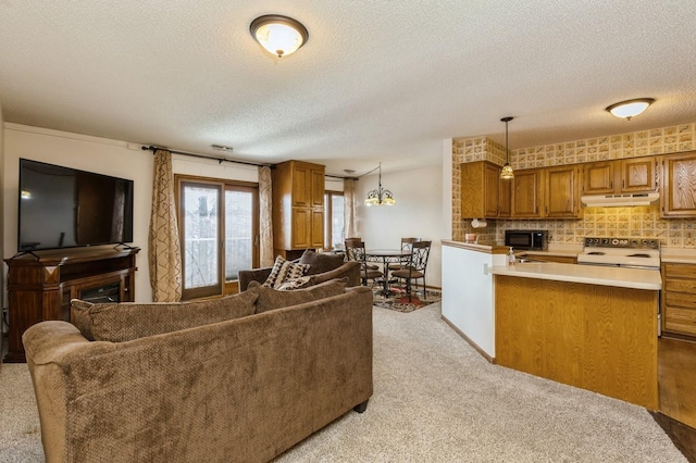 carpeted living room featuring a textured ceiling