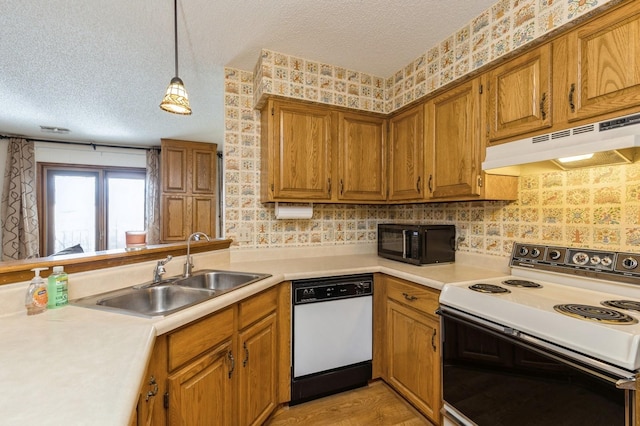 kitchen with pendant lighting, sink, dishwasher, electric range, and kitchen peninsula