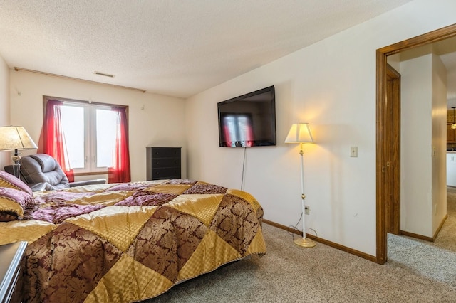 carpeted bedroom featuring a textured ceiling