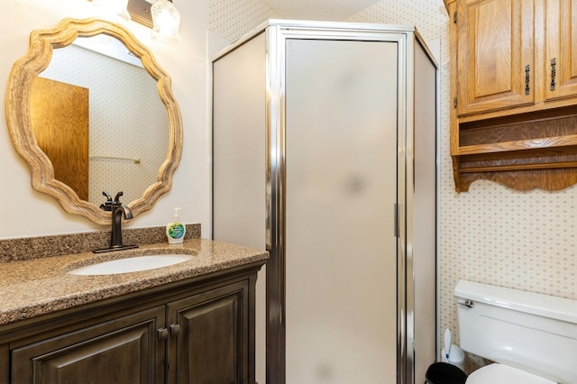 bathroom featuring walk in shower, vanity, and toilet