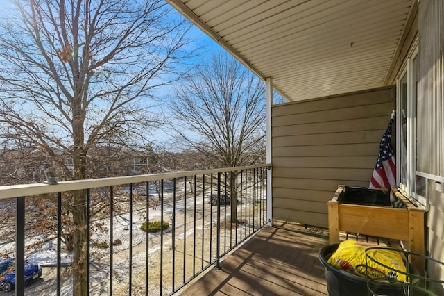 view of snow covered back of property