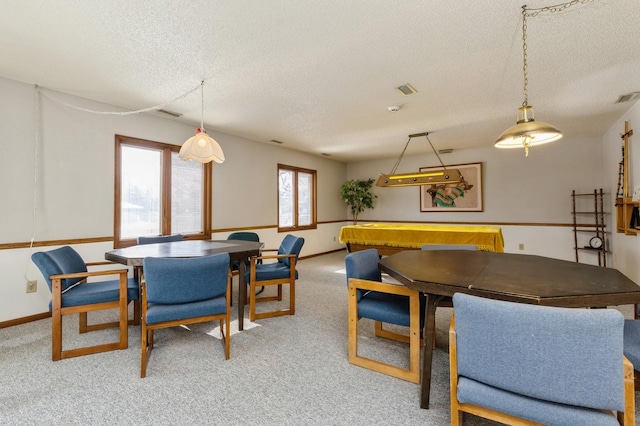 dining space featuring a textured ceiling and carpet flooring