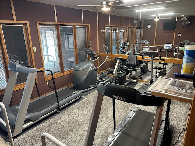 exercise room with ceiling fan