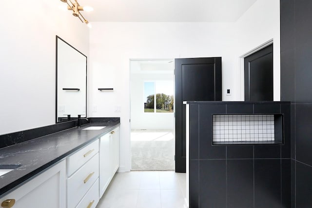 bathroom with double vanity, tile patterned flooring, and a sink