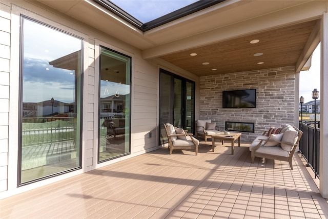 wooden terrace featuring outdoor lounge area