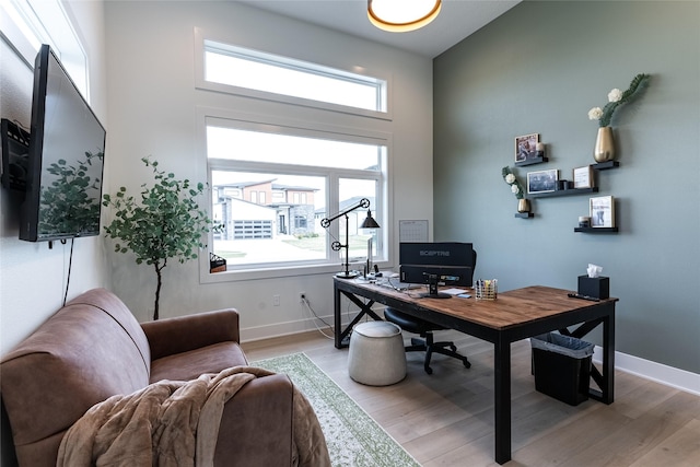 office area with baseboards and wood finished floors